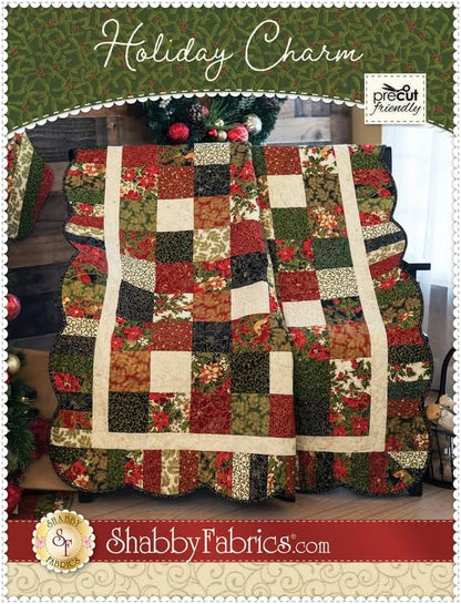 A quilt with a multicolored floral pattern, featuring red, green, and white, with a scalloped border and hand embroidery detail.
Photo by Shannon Fabrics [image_link]