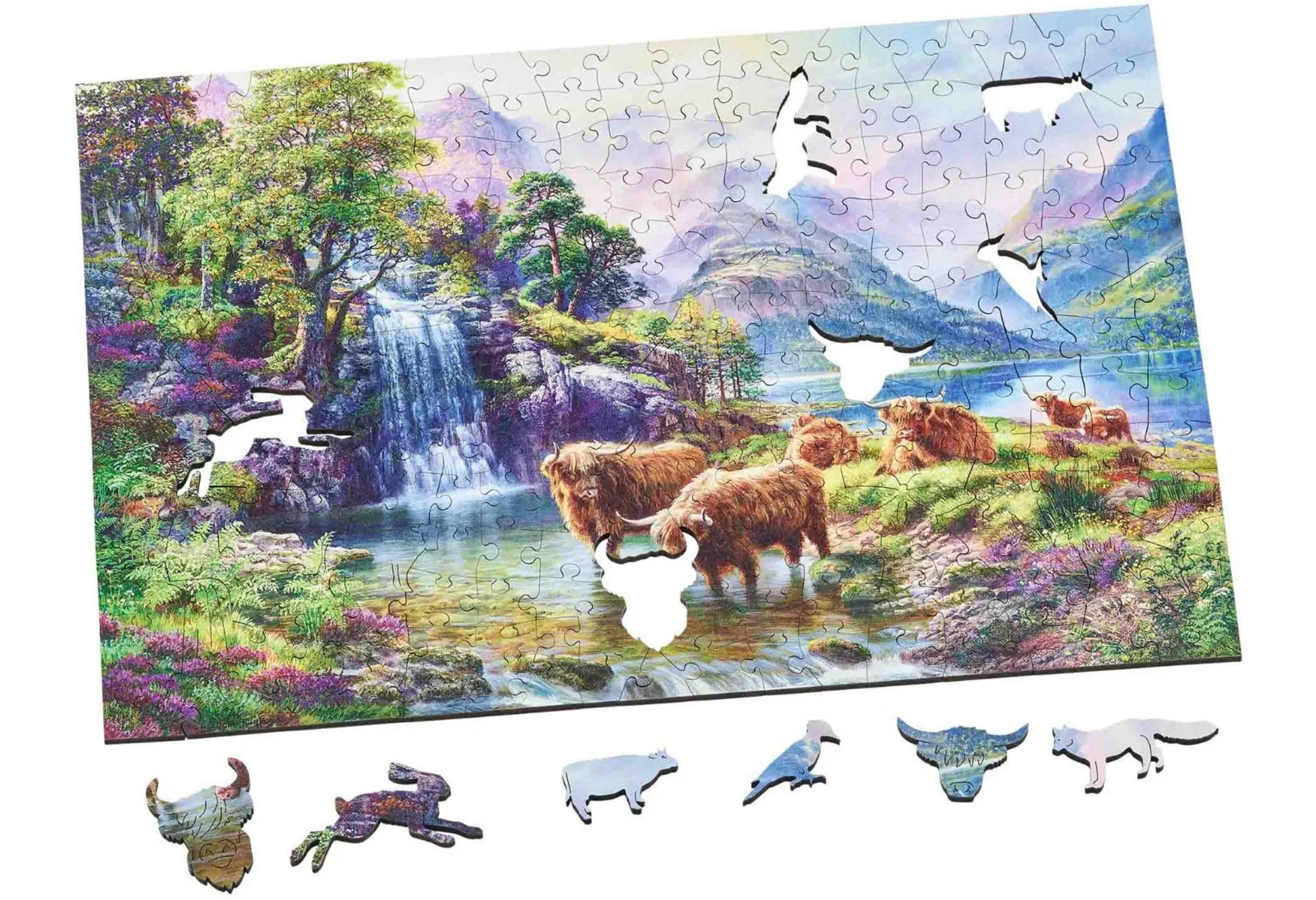 A wooden jigsaw puzzle depicting a highland landscape scene with cows, a waterfall, and mountains in the background.
Photo by Wentworth Puzzles [additional_image_link]