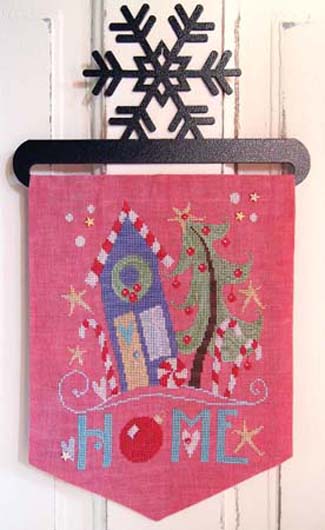 Decorative banner with a house, tree, and snowflake design on a pink background.
Photo by SamSarah Studio Designs [image_link]