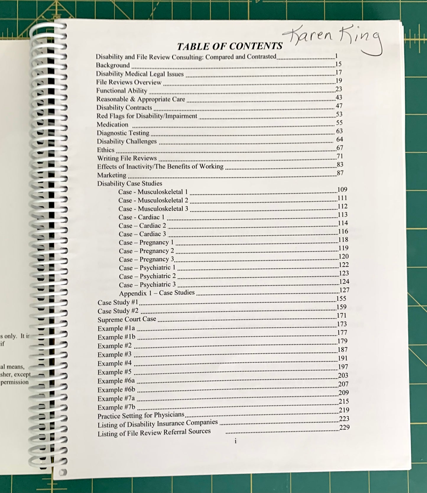 A spiral-bound spiral notebook showing an open table of contents page, photographed on a green cutting mat. The page has black text and a handwritten name 'Karen King' at the top.
[additional_image_link]