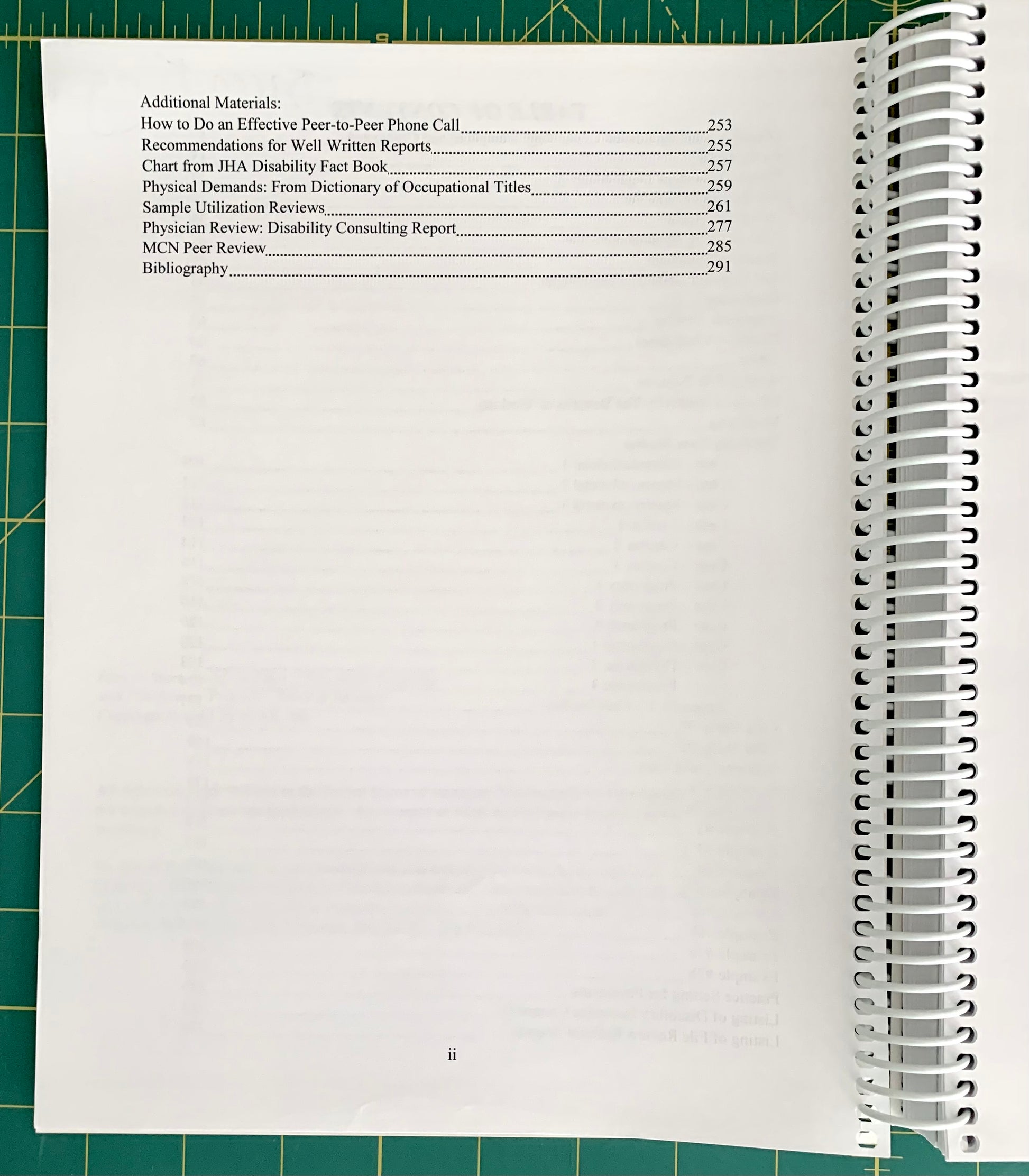 A spiral-bound spiral notebook showing an open table of contents page, photographed on a green cutting mat. 
[additional_image_link]