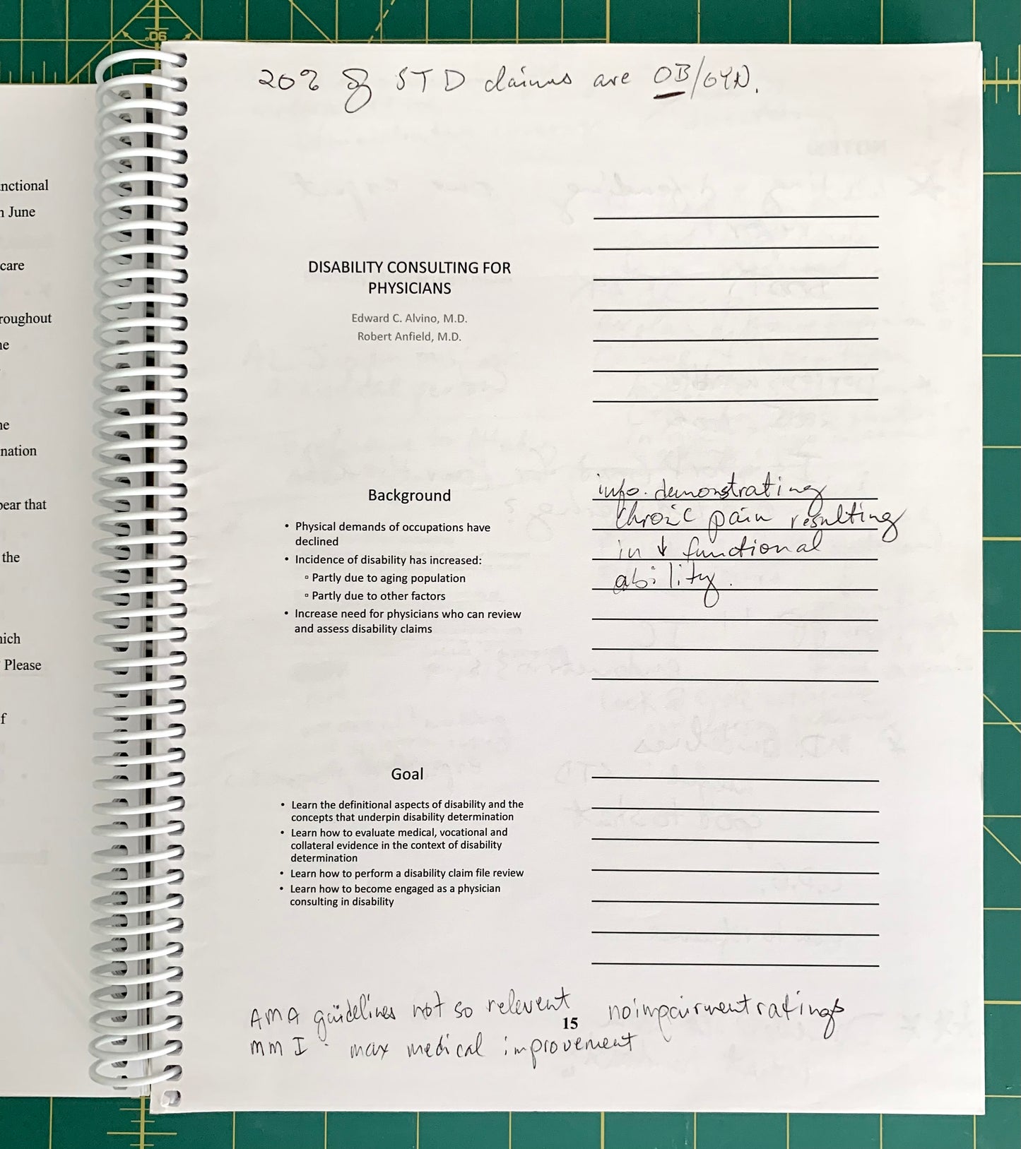 A spiral-bound notebook page with printed text about disability consulting for physicians and handwritten notes, photographed on a green cutting mat.
[additional_image_link]