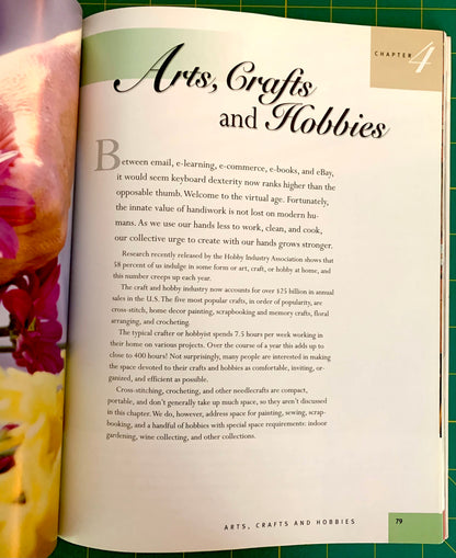 An open book page showing the chapter title 'Arts, Crafts and Hobbies' with body text, photographed with a hand holding the left page edge against a green cutting mat background.
[additional_image_link]