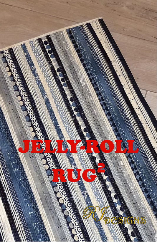 A rectangular area rug with a Jelly Roll pattern, featuring a variety of fabric stripes in different shades of blue and beige, and the text 'JELLY ROLL RUG' prominently displayed.
Photo by R.J .Designs [image_link]