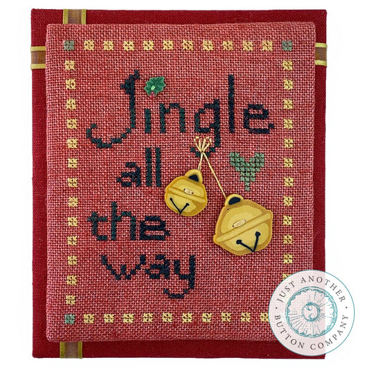 Decorative red fabric with 'Jingle all the way' text and yellow bells, featuring the 'Just Another Button Company' logo.
Photo by JustAnotherButtonCompany.com [image_link]