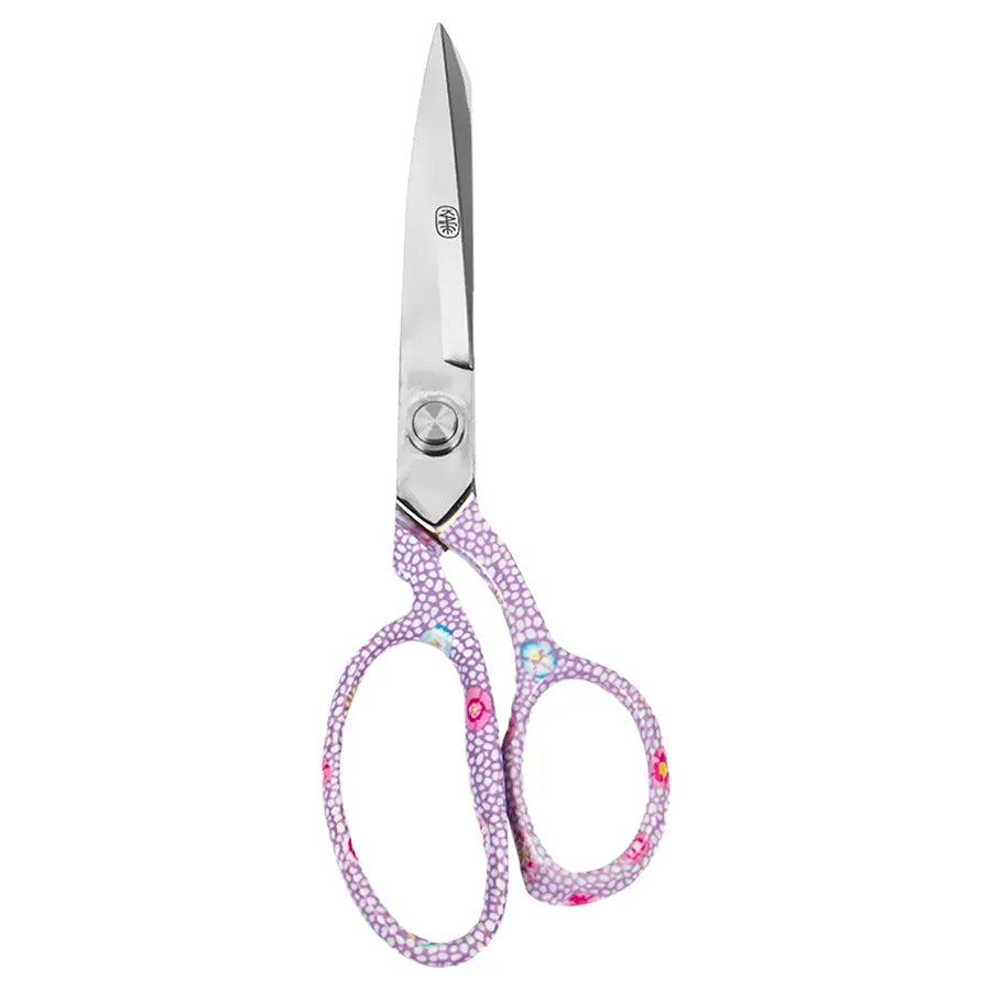 A pair of scissors with silver metal blades and handles decorated with a dense pattern of small pink, purple, and white flowers, isolated on a white background.
Photo by Kaffe Fassett [additional_image_link]