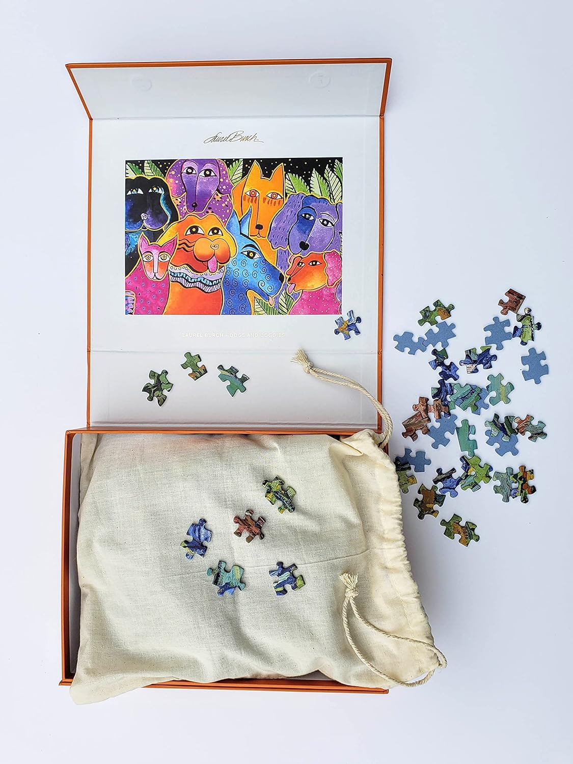 Monarque 1000-piece jigsaw puzzle box featuring a colorful, stylized illustration of various dog faces on a bright orange background.
Photo by Monarque [additional_image_link]
