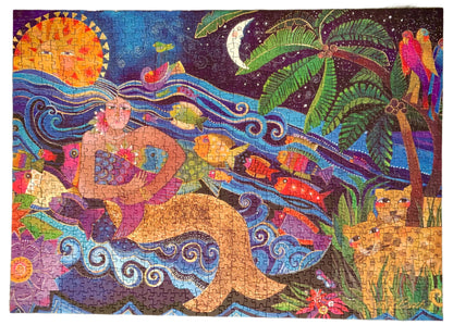 A colorful jigsaw puzzle box featuring a sea goddess design with a vibrant background and tropical elements.
Photo by Karen King [additional_image_link]