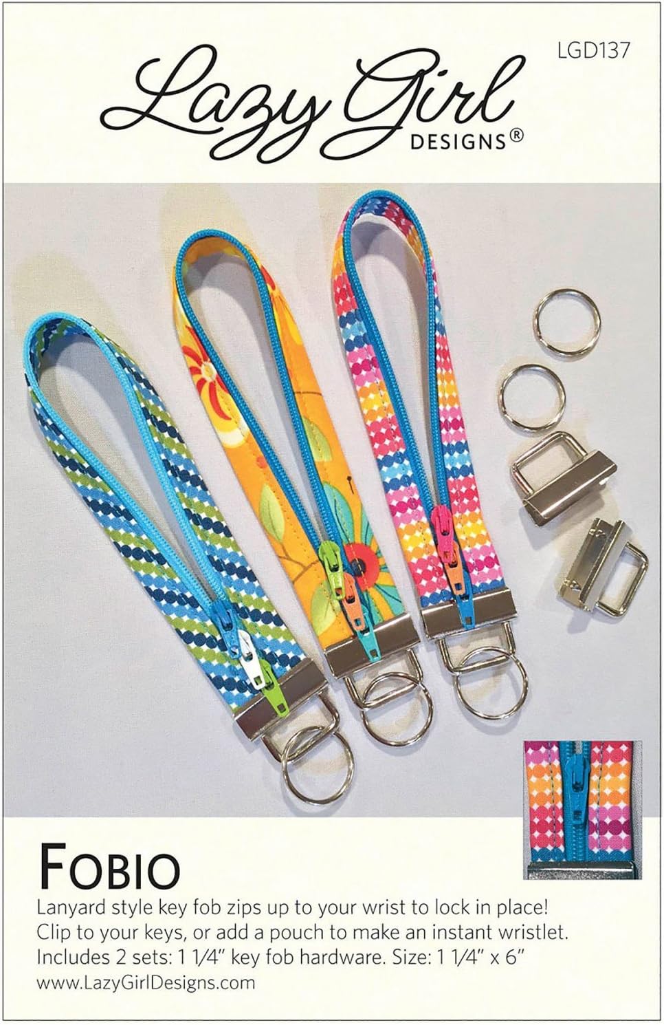 Three colorful patterned lanyard key fobs with metal key rings and clasp hardware are displayed on a white background with product text and branding. The top reads 'Lazy Girl Designs' and the bottom reads 'FOBIO' with a small inset showing the lanyard folded.
[additional_image_link]