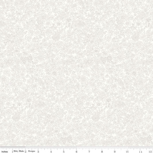 A close-up of a light cream fabric with a subtle, tonal damask or floral scroll pattern, featuring a white ruler scale at the bottom indicating 12 inches.
Photo by RileyBlakeDesigns.com [image_link]