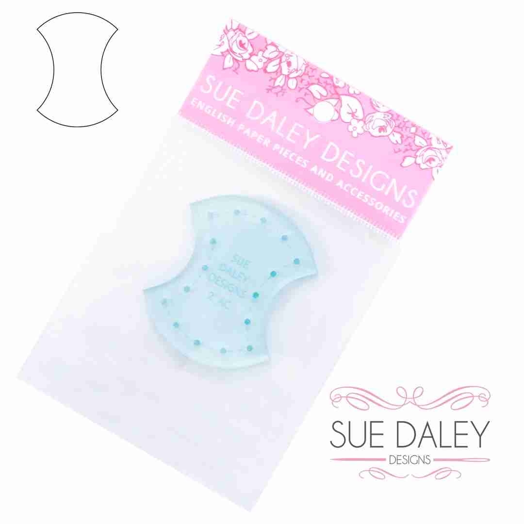 A light blue acrylic template from Sue Daley Designs, packaged in a clear plastic sleeve with a pink floral header card. A black line drawing of the template shape is shown in the upper left corner, and the brand logo is in the lower right.
Photo by Sue Daley [additional_image_link]