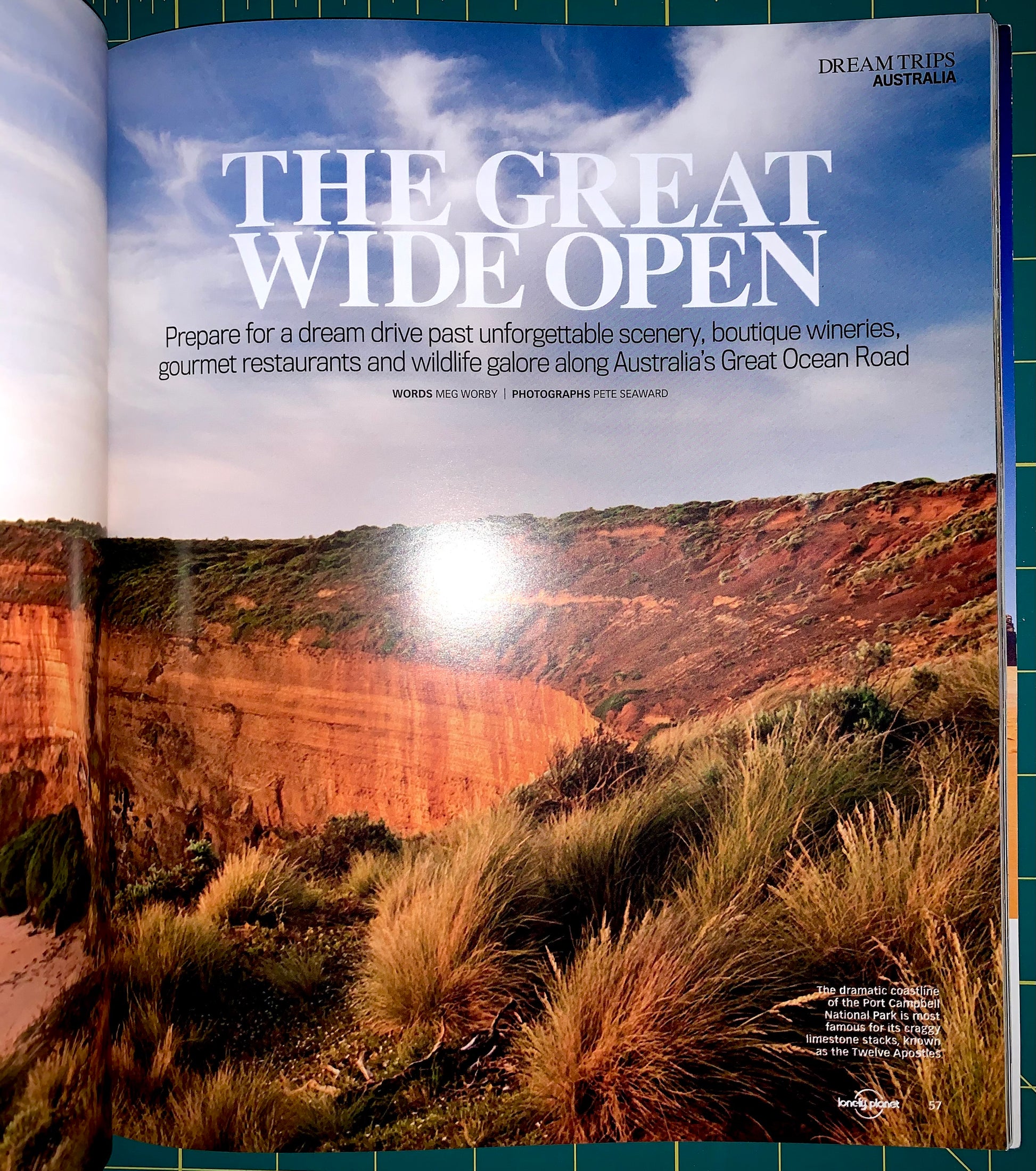 An open magazine or brochure spread showing a large scenic photograph of a canyon landscape with the headline 'THE GREAT WIDE OPEN' and smaller travel copy. The visible brand text at the top right reads 'DREAM TRIP AUSTRALIA'.
[additional_image_link]