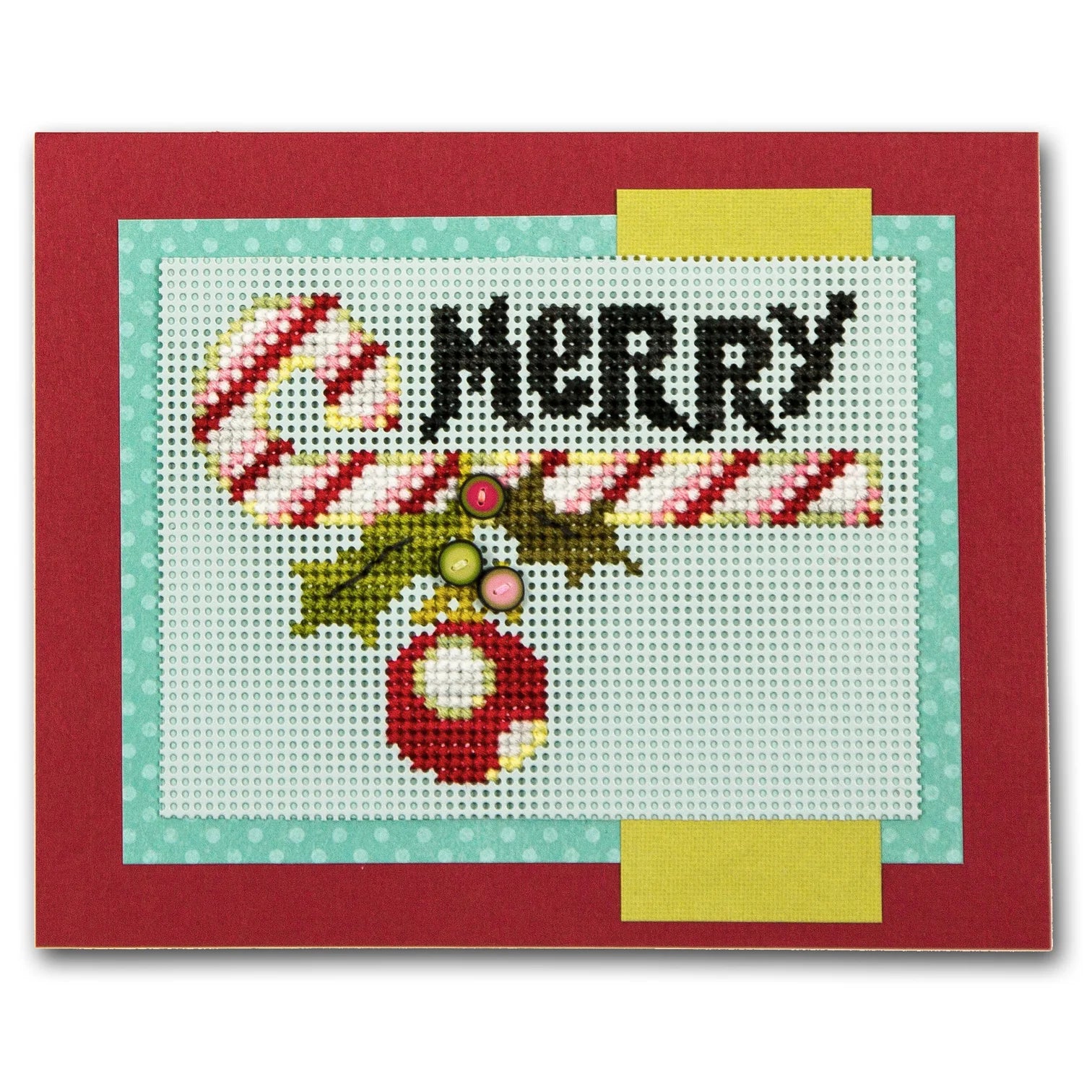 A square handmade cross-stitch card featuring a festive holiday design with the word 'MERRY' in black, a candy cane, holly leaves, and a red ornament on white stitched fabric, bordered by light blue and yellow strips and a red outer border.
Photo by JustAnotherButtonCompany.com [additional_image_link]