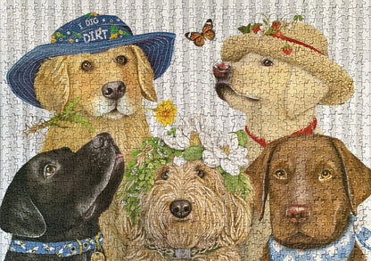 A completed 1000-piece jigsaw puzzle box with an illustration of various dogs and floral elements on the cover, featuring the Monarque brand name.
Photo by Karen King [additional_image_link]