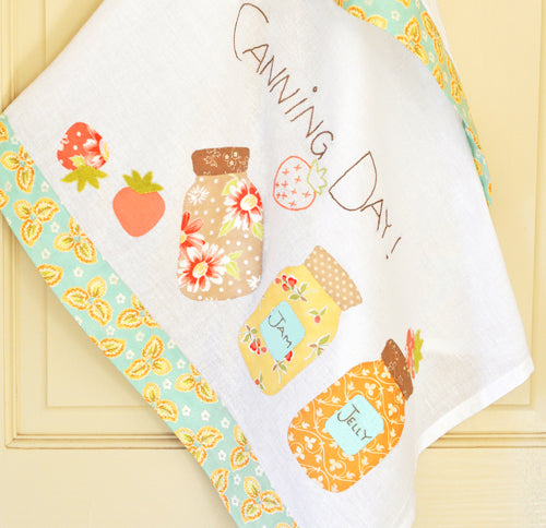 A Fig Tree Quilts kitchen towel pattern, featuring a completed towel with mason jar designs.
Photo by Fig Tree & Co. [additional_image_link]