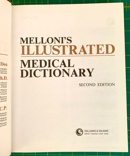 Melloni's Illustrated Medical Dictionary, Second Edition, showing the open title page on a green cutting mat background.
[additional_image_link]