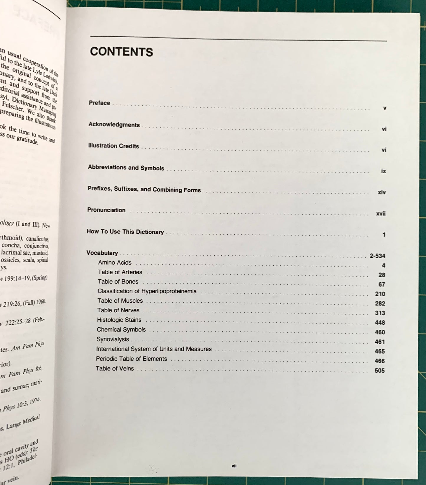 An open book showing the contents page in English, photographed from below on a green cutting mat with a grid pattern.
[additional_image_link]