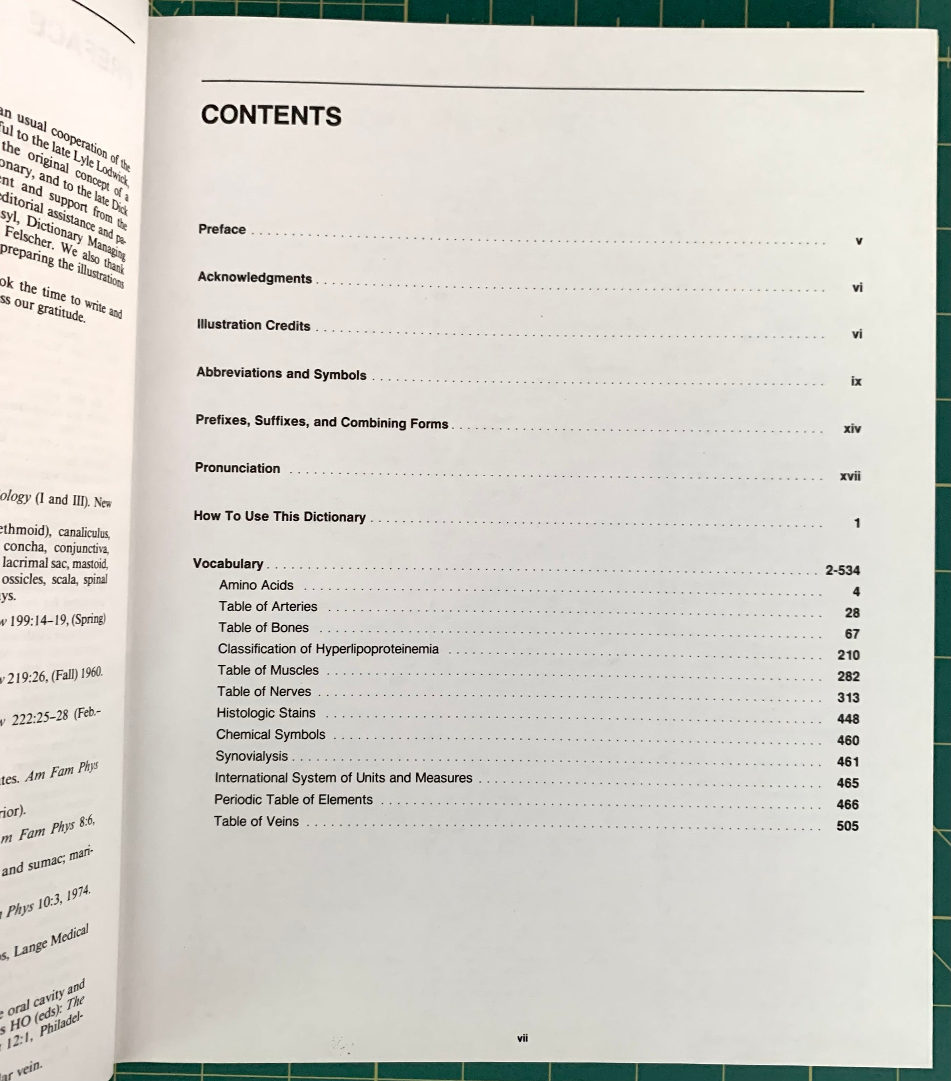 An open book showing the contents page in English, photographed from below on a green cutting mat with a grid pattern.
[additional_image_link]