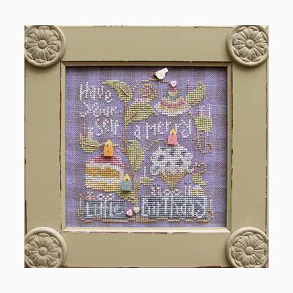 Decorative framed cross-stitched piece with a cake design and text on a purple background.
Photo by SamSarah Studio Designs [image_link]