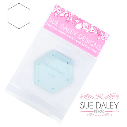 A light blue hexagonal paper clip accessory in a clear plastic bag with a pink 'SUE DALEY DESIGNS' header card, shown on a white background with the brand logo and a faint hexagon outline.
Photo by Sue Daley [additional_image_link]