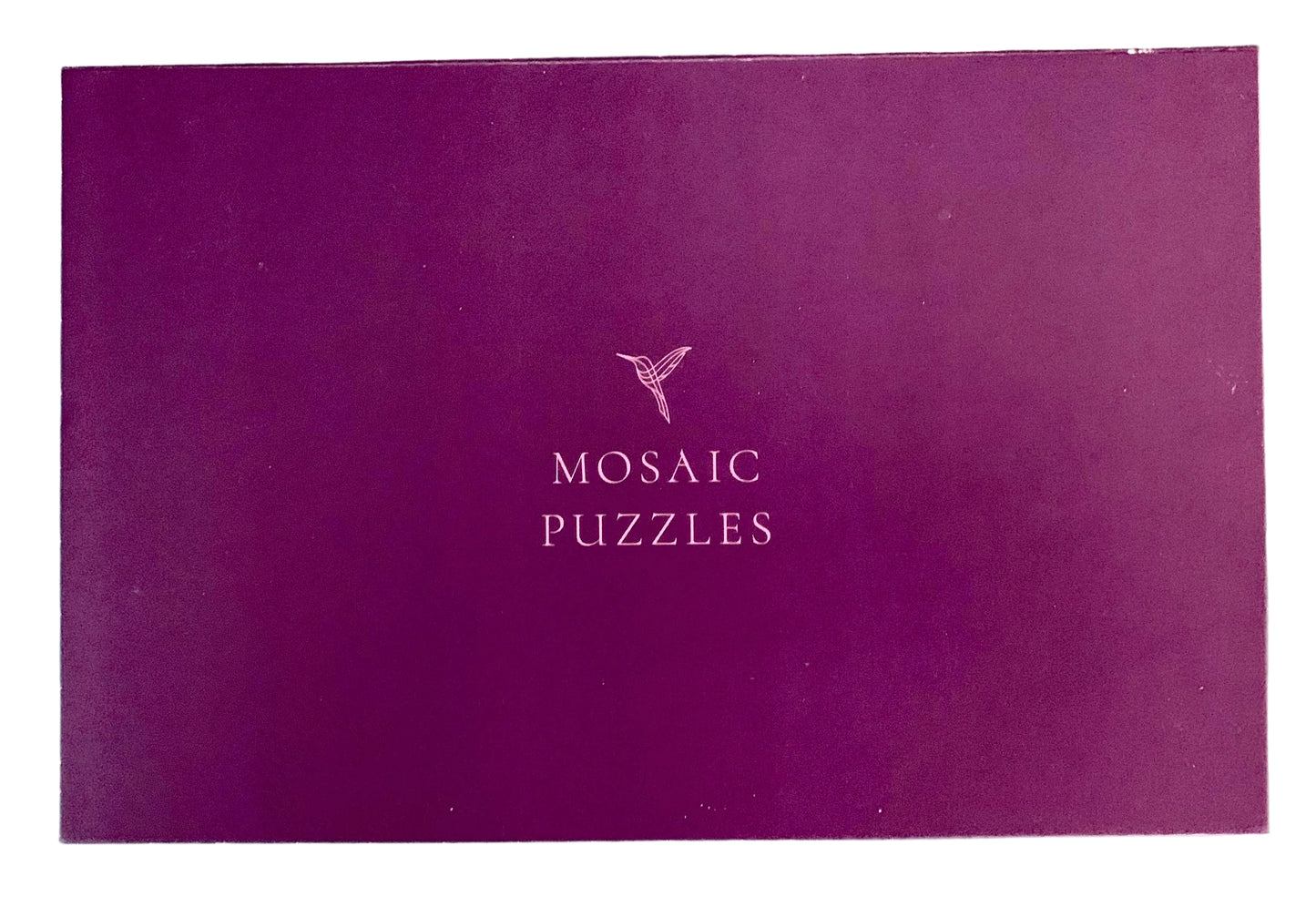 A purple rectangular box with the words 'MOSAIC PUZZLES' and a small bird logo printed in the center.
Photo by Karen King [additional_image_link]