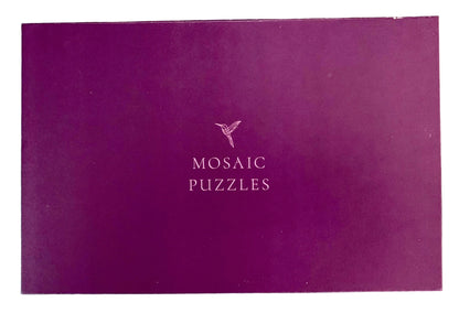 A purple rectangular box with the words 'MOSAIC PUZZLES' and a small bird logo printed in the center.
Photo by Karen King [additional_image_link]