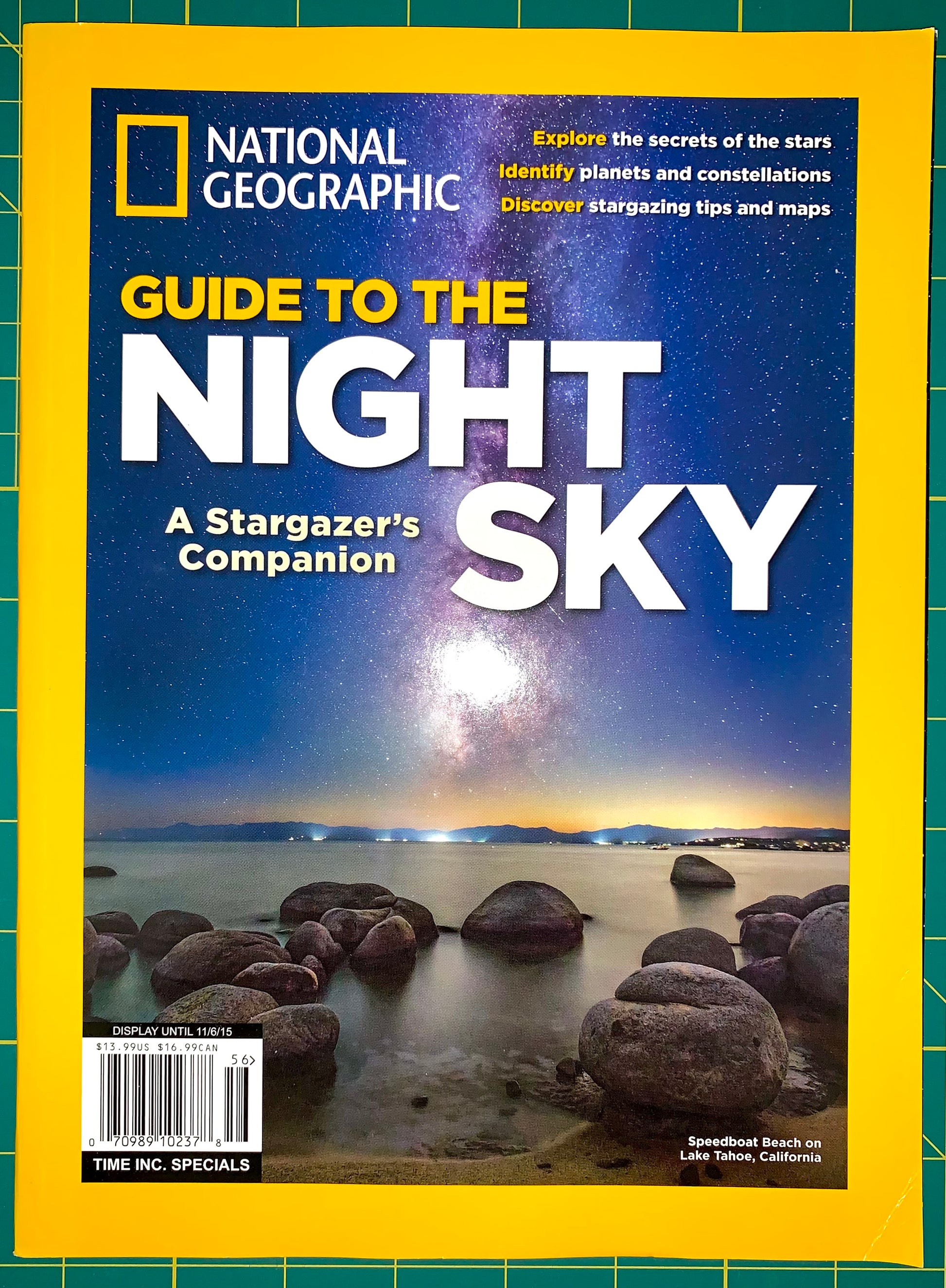 National Geographic magazine cover featuring the headline 'Guide to the Night Sky' with a night-sky landscape photo and rocky shoreline, framed by the signature yellow border.
[image_link]