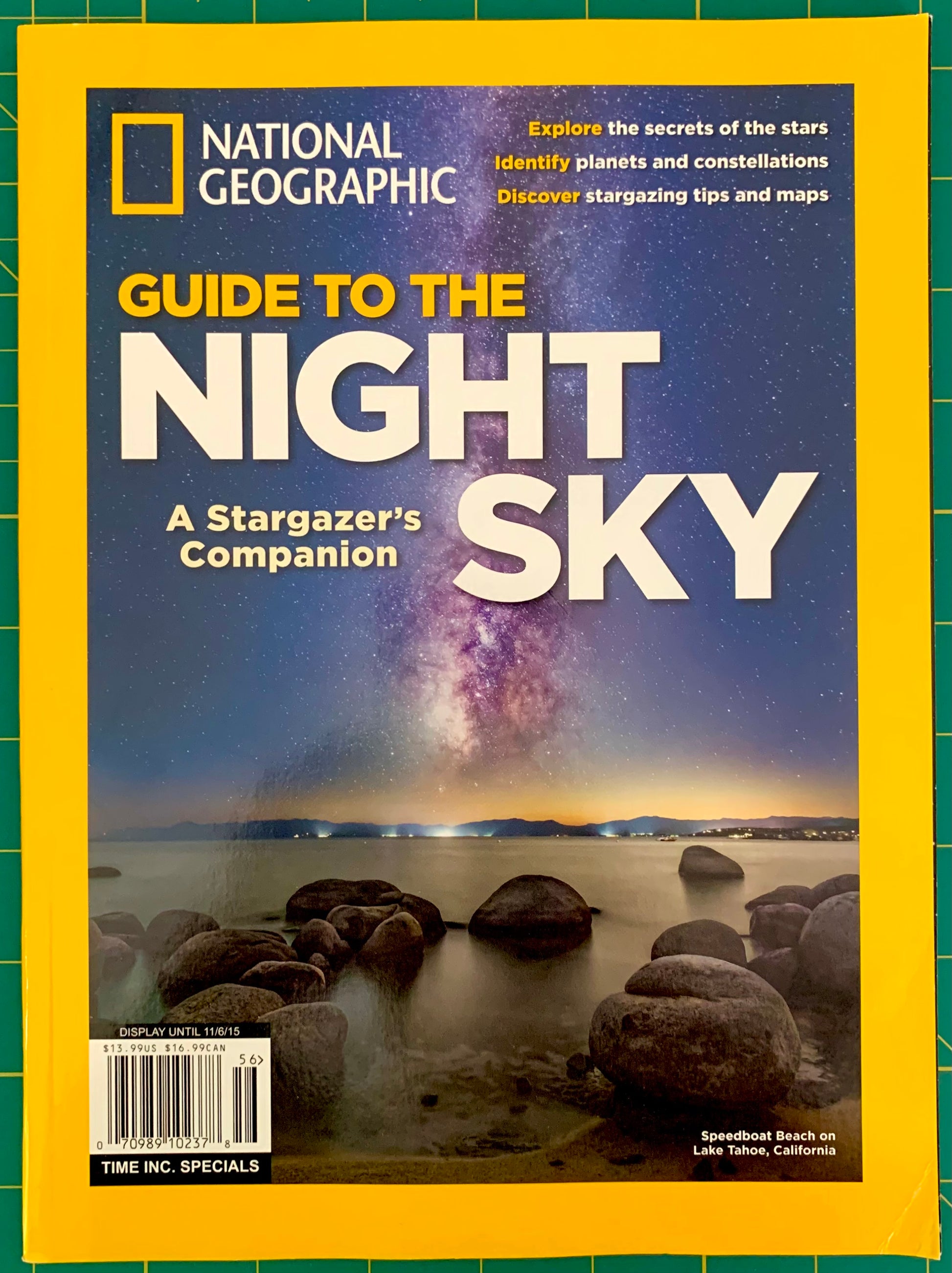 National Geographic magazine cover featuring the headline 'Guide to the Night Sky' with a night-sky landscape photo and rocky shoreline, framed by the signature yellow border.
[additional_image_link]