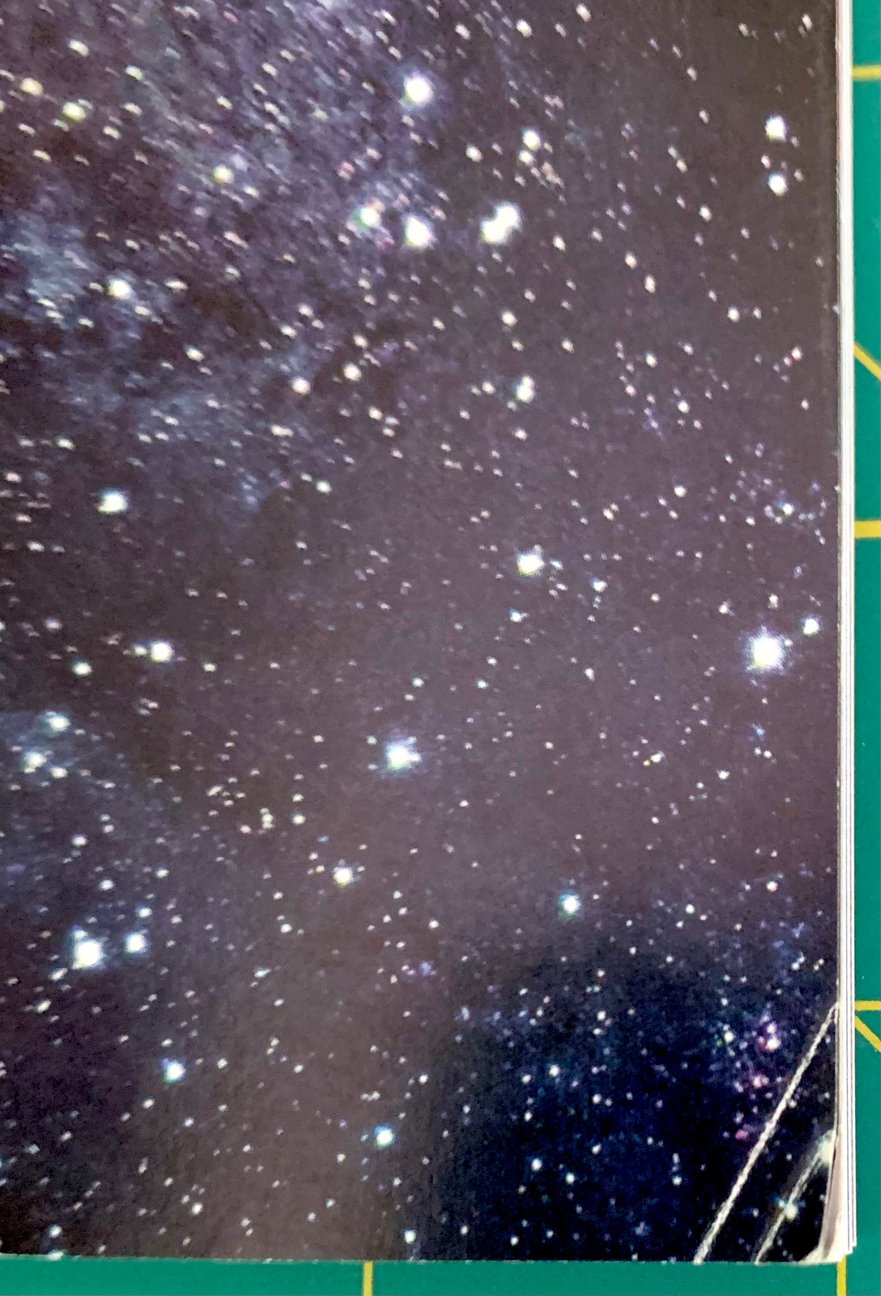 A close-up of a starry night sky print or texture, with numerous bright stars scattered across a dark space background. A small portion of a green and yellow object is visible along the right edge.
[additional_image_link]