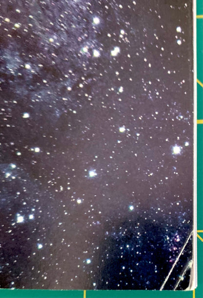 A close-up of a starry night sky print or texture, with numerous bright stars scattered across a dark space background. A small portion of a green and yellow object is visible along the right edge.
[additional_image_link]