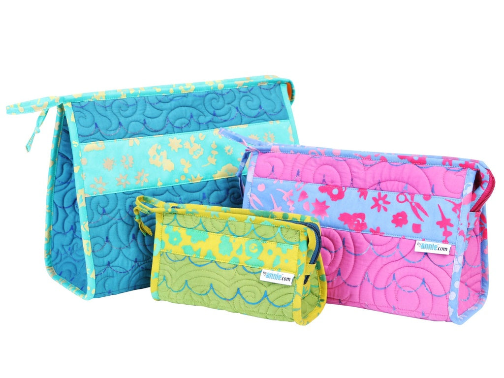 Set of colorful quilted bags with floral patterns on a white background.
Photo by Annie [additional_image_link]