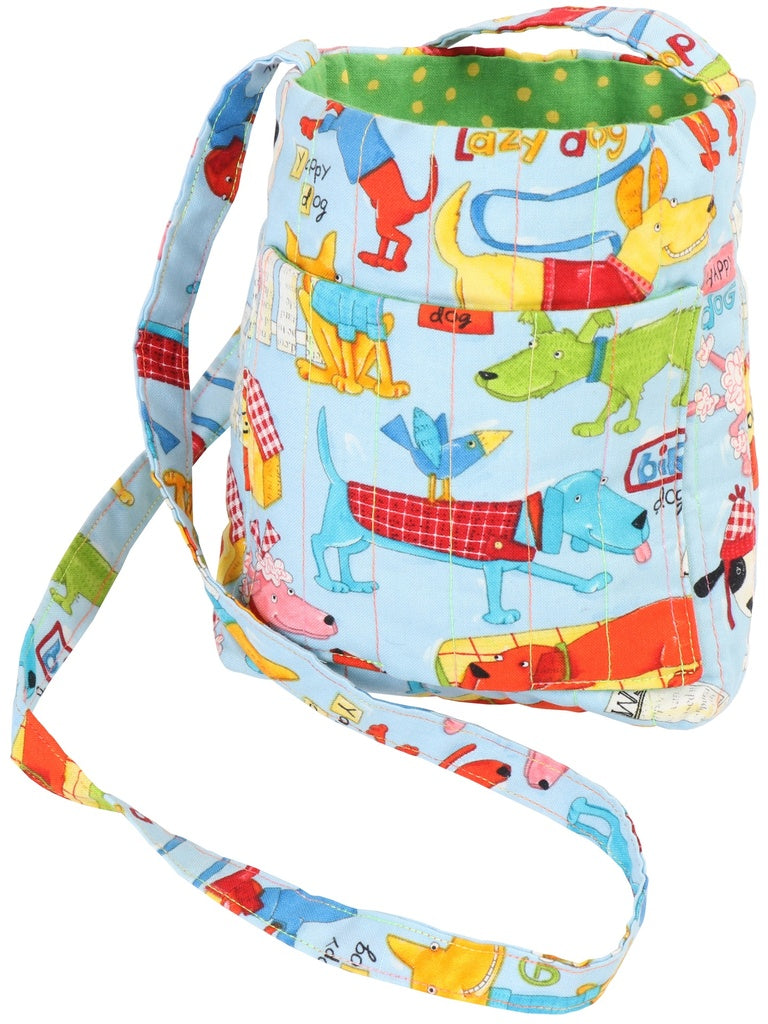 A small fabric shoulder bag with a light blue background and a colorful cartoon dog print, featuring a green polka-dot top trim and a matching adjustable strap.
[additional_image_link]