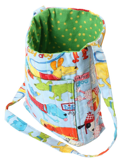 A fabric shoulder bag with a light blue background printed with colorful cartoon dogs, a green polka-dot interior lining, and a matching adjustable strap.
[additional_image_link]