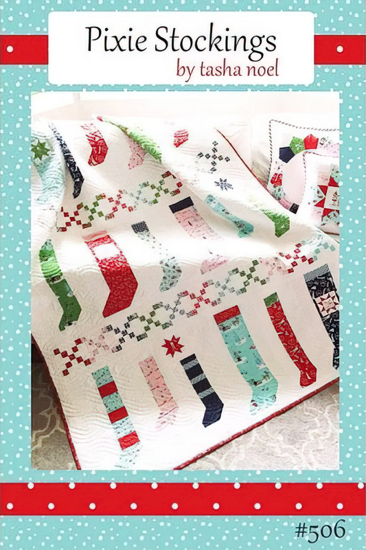 A quilted patchwork blanket featuring Christmas stocking patterns in red, green, black, and light blue on an off-white background, presented in a product cover layout with the title 'Pixie Stockings by tasha noel'.Photo by RileyBlakeDesigns.com [image_link]