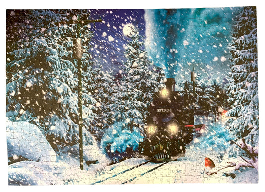 A pre-owned wooden jigsaw puzzle depicting a scene with a train and snow-covered trees, with puzzle pieces scattered around.
Photo by Karen King [image_link]