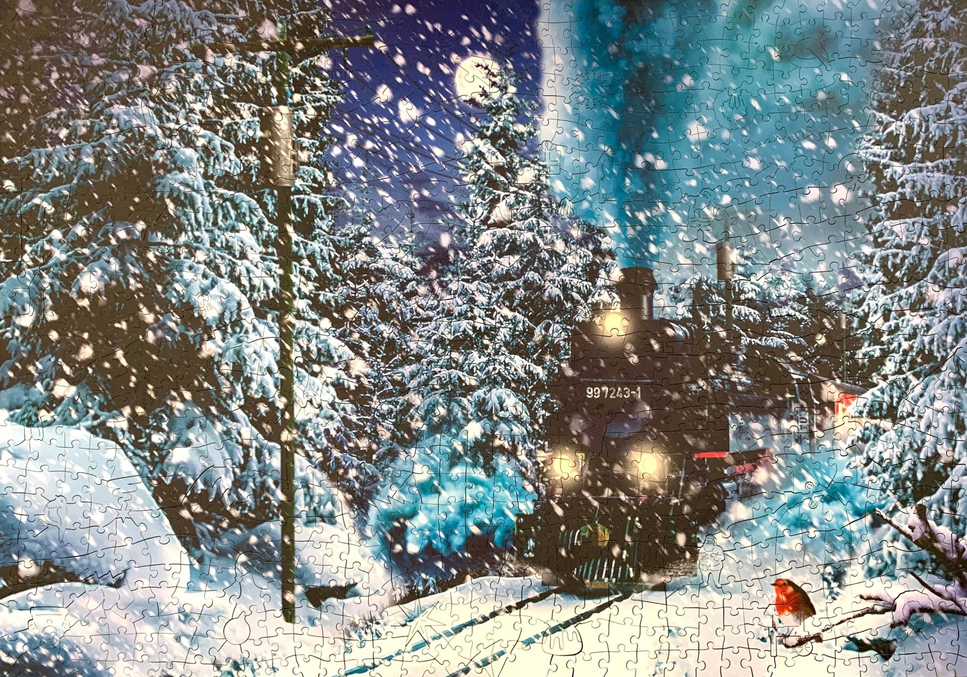 A pre-owned wooden jigsaw puzzle depicting a scene with a train and snow-covered trees, with puzzle pieces scattered around.
Photo by Karen King [additional_image_link]