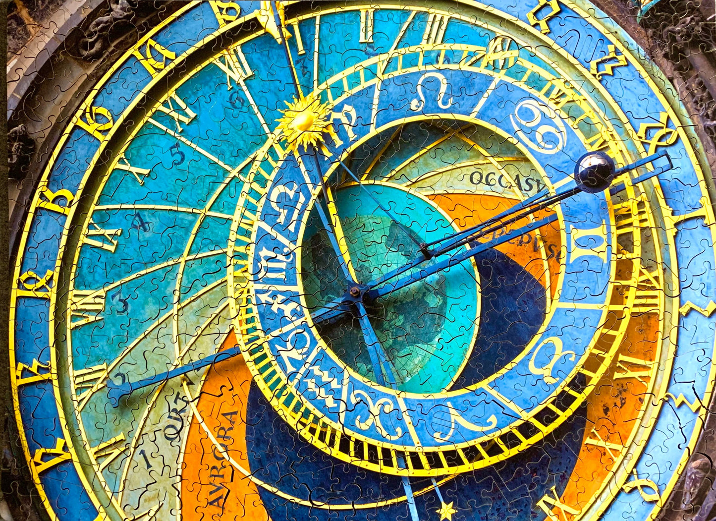 A completed wooden jigsaw puzzle depicting the Prague Astronomical Clock, with a richly colored design and various time-keeping elements.
Photo by Karen King [additional_image_link]