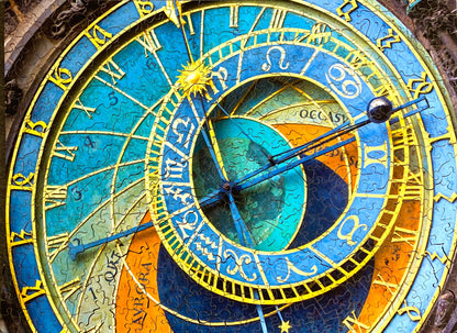 A completed wooden jigsaw puzzle depicting the Prague Astronomical Clock, with a richly colored design and various time-keeping elements.
Photo by Karen King [additional_image_link]