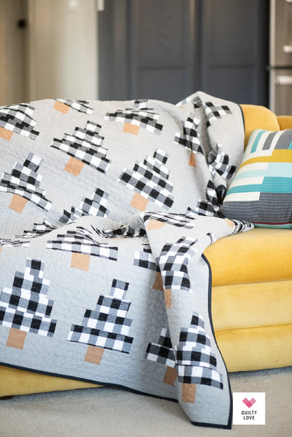 Patterned quilt draped over a yellow sofa with a neutral background.
Photo by Quilty Love [additional_image_link]