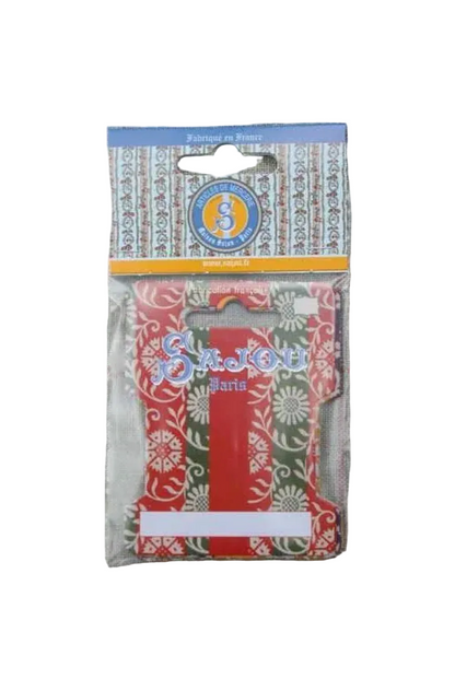 A packaged decorative ribbon cards or insert with a red, green, and white floral pattern, shown inside clear plastic retail packaging on a textured gray fabric background.
Photo by Sajou.fr [additional_image_link]