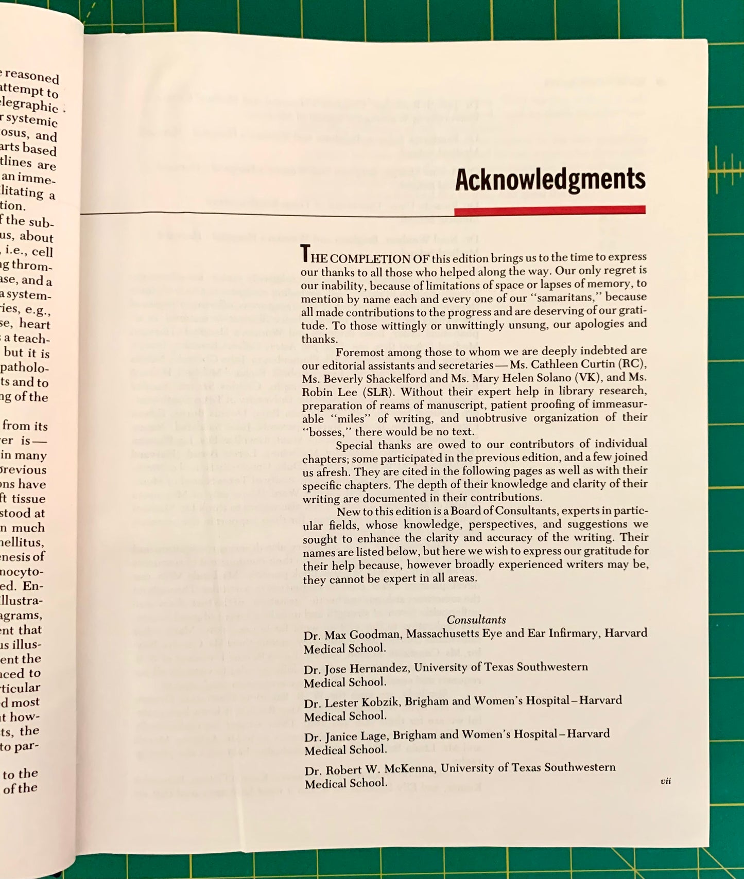An open book spread showing printed text and a red 'Acknowledgments' heading, photographed against a green grid background.
[additional_image_link]