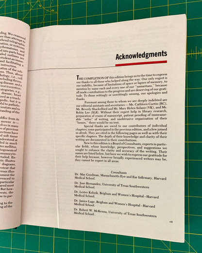 An open book showing the 'Acknowledgments' page, photographed from above on a green cutting mat with grid lines.
[additional_image_link]