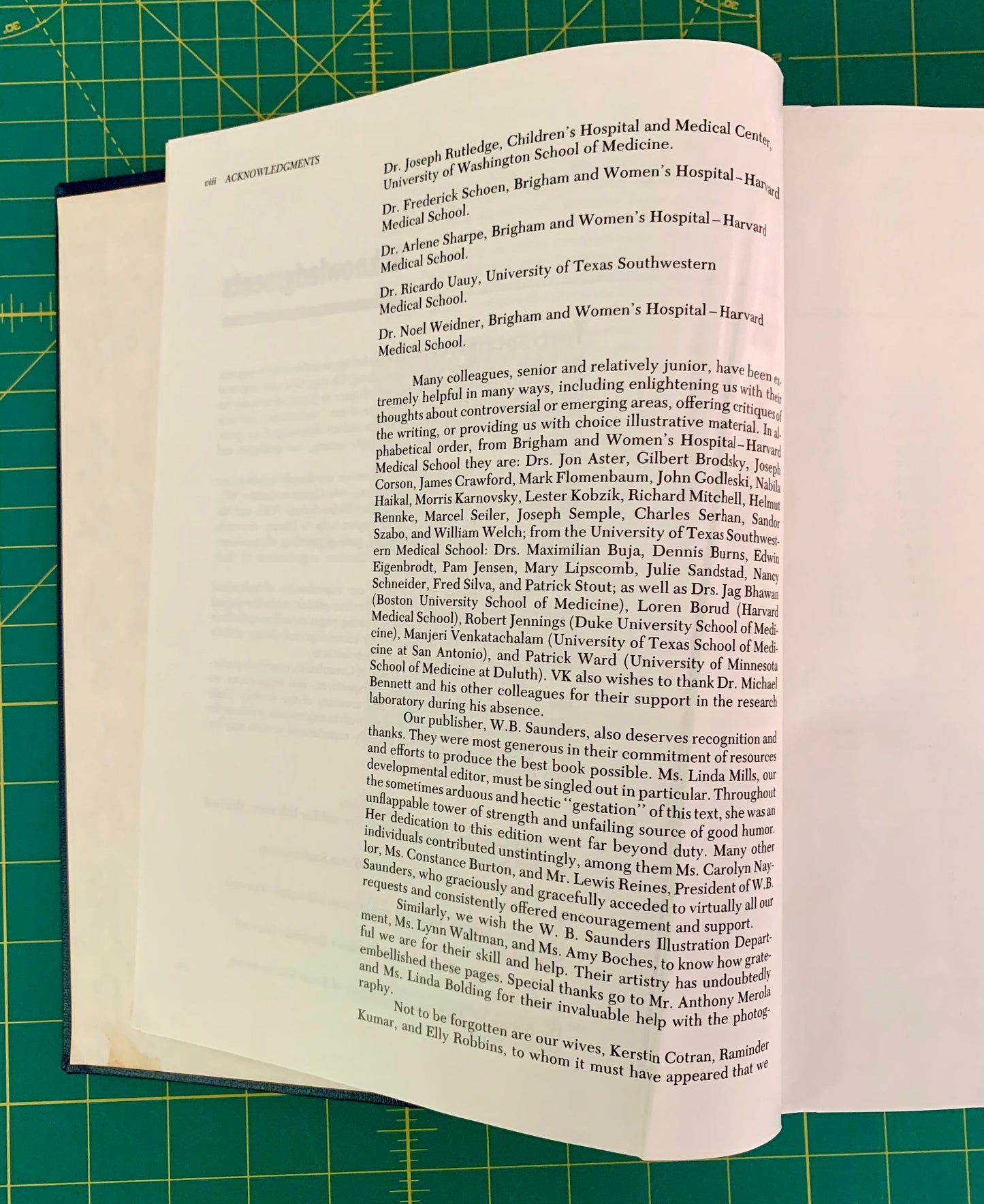 A printed page from a book or magazine laid flat on a green cutting mat, showing black text on an off-white page.
[additional_image_link]