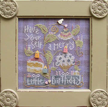 Decorative framed cross-stitched piece with birthday-themed design and text. Photo by SamSarah Studio Designs [additional_image_link]