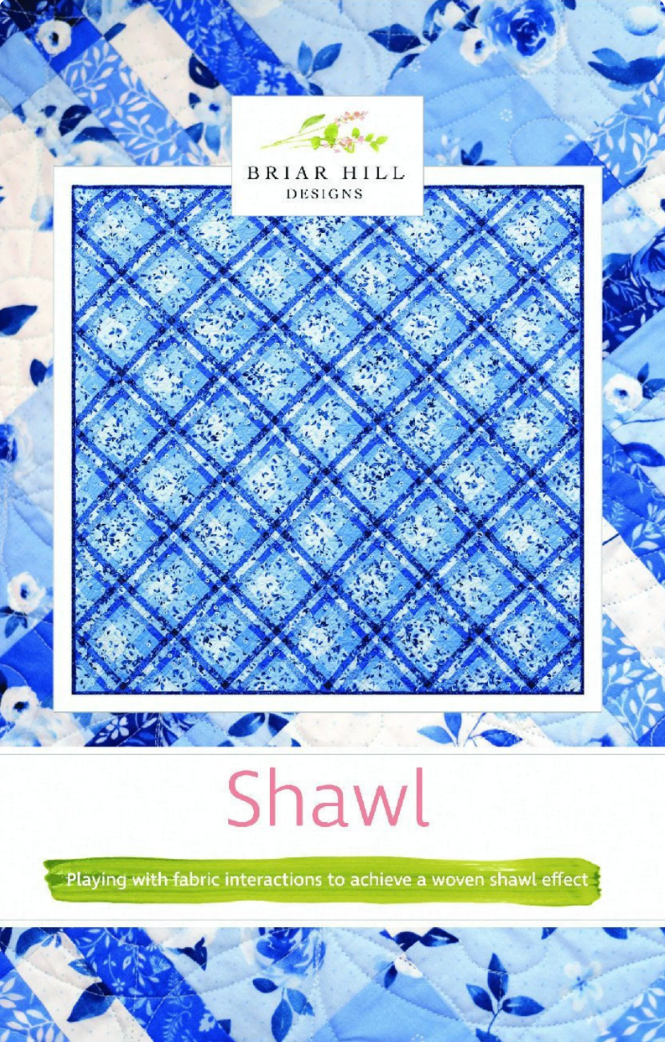 A quilt pattern designed by Julie Wentzell for Briar Hill Designs, featuring a blue and white geometric pattern resembling a woven shawl.
Photo by Briar Hill Designs [image_link]