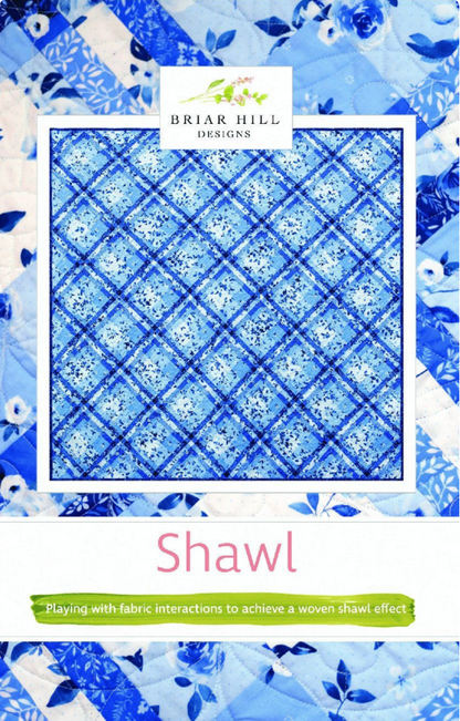 A quilt pattern designed by Julie Wentzell for Briar Hill Designs, featuring a blue and white geometric pattern resembling a woven shawl.
Photo by Briar Hill Designs [image_link]