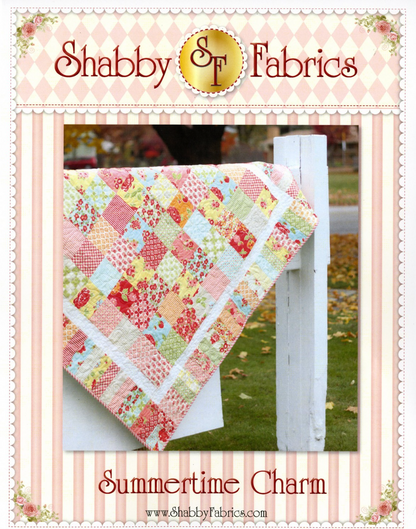 A quilt with a patchwork design featuring various colors, draped over a white wooden fence, with 'Shabby & Fabrics' branding at the top.
Photo by Shannon Fabrics [image_link]