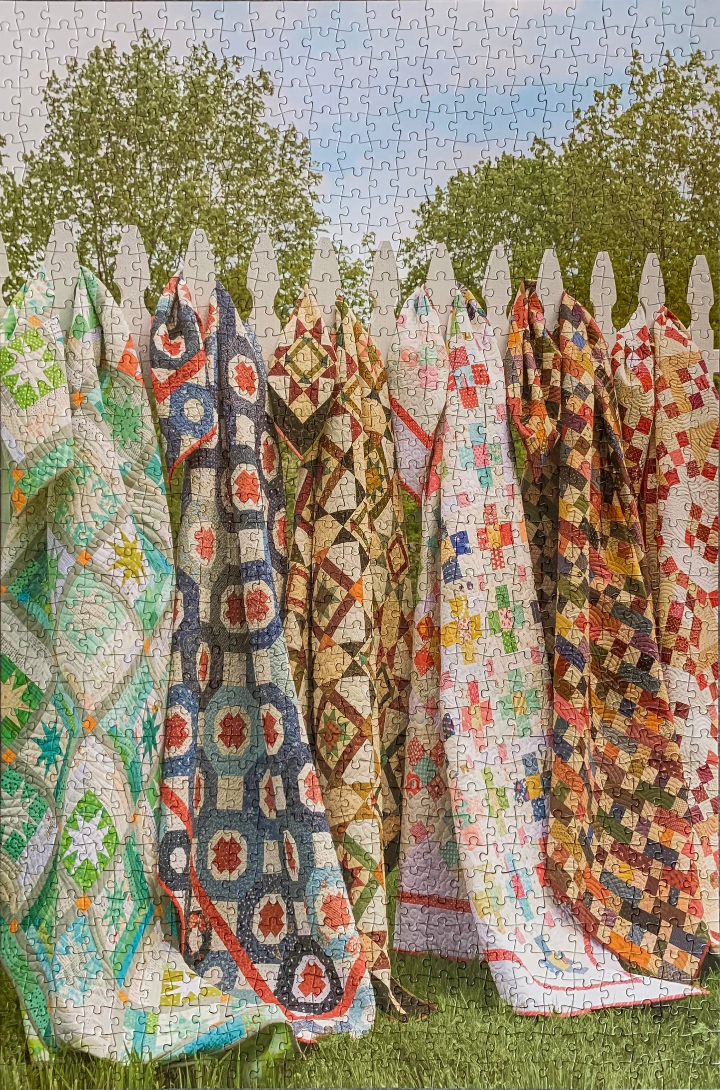 A collection of jigsaw puzzle pieces with various quilt patterns, assembled together to form a larger image.
Photo by Karen King [additional_image_link]