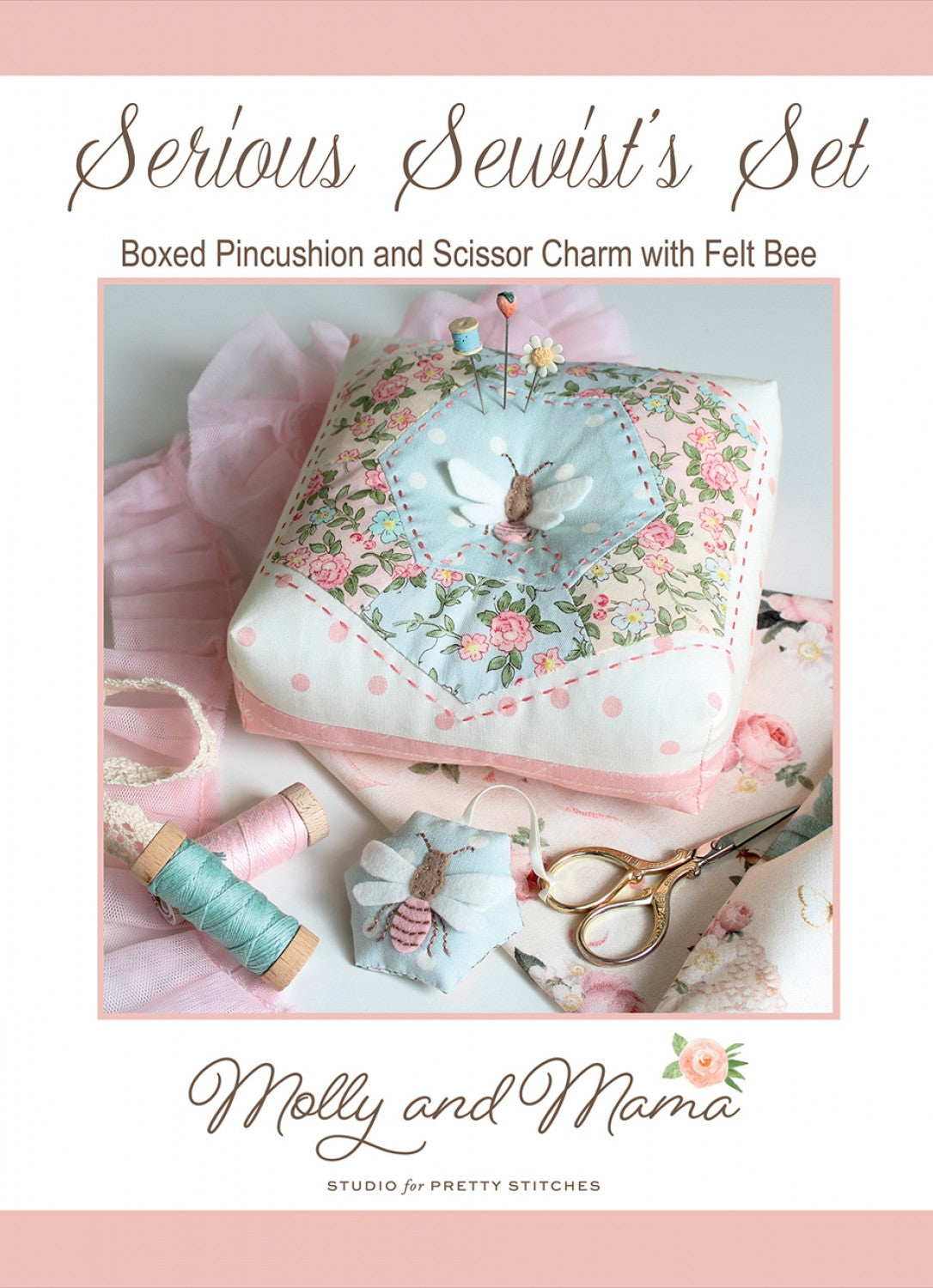 Boxed pincushion with felt bee and sewing accessories on a pink background, featuring Molly and Mama branding.
Photo by Molly and Mama [image_link]
