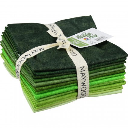 A bundle of Shadow Play green fat quarters by Maywood Studio, tied together with a ribbon.
Photo by MaywoodStudios.com [image_link]